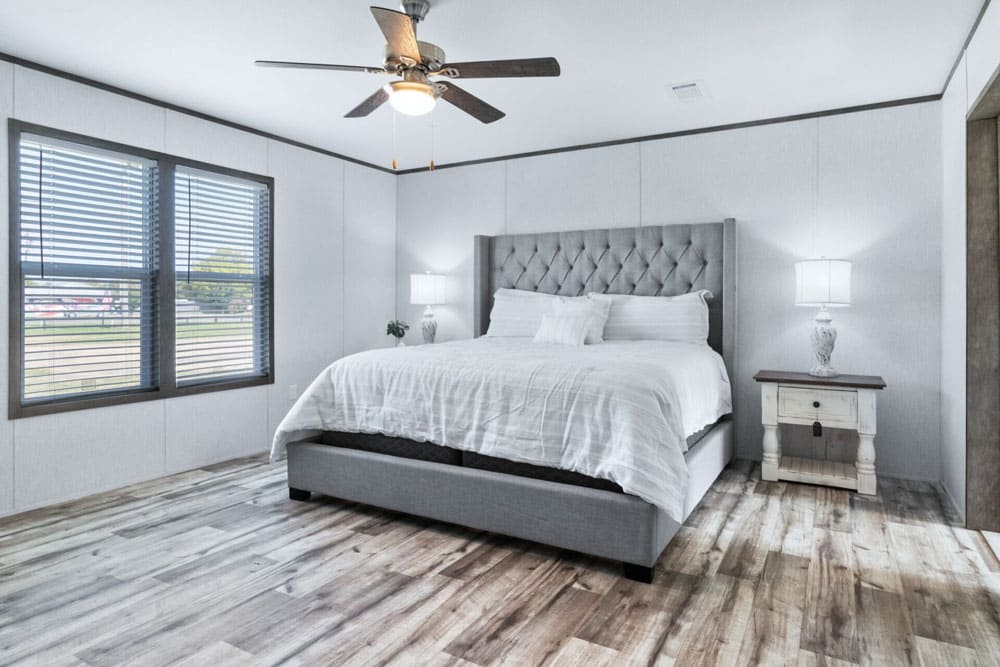 Primary bedroom with large windows in The Murphy by Jessup Housing