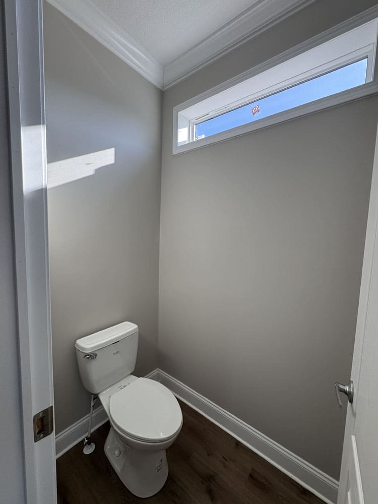 Private toilet room with transom window in The Lilly II modular home