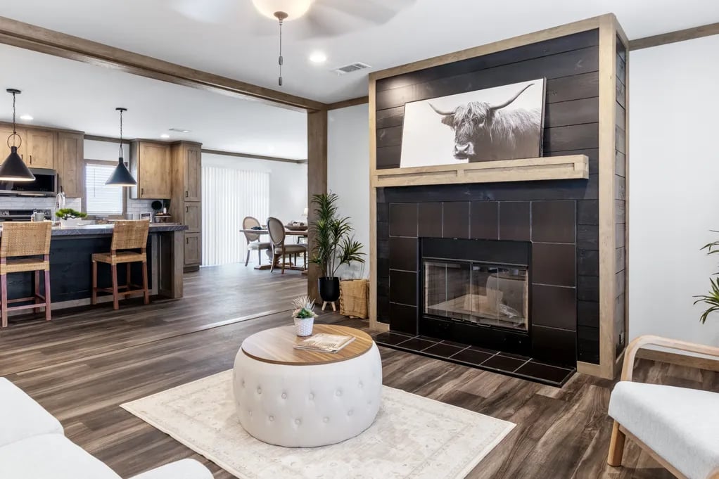 Isabella Elite living room with black fireplace and open kitchen by Clayton NXT