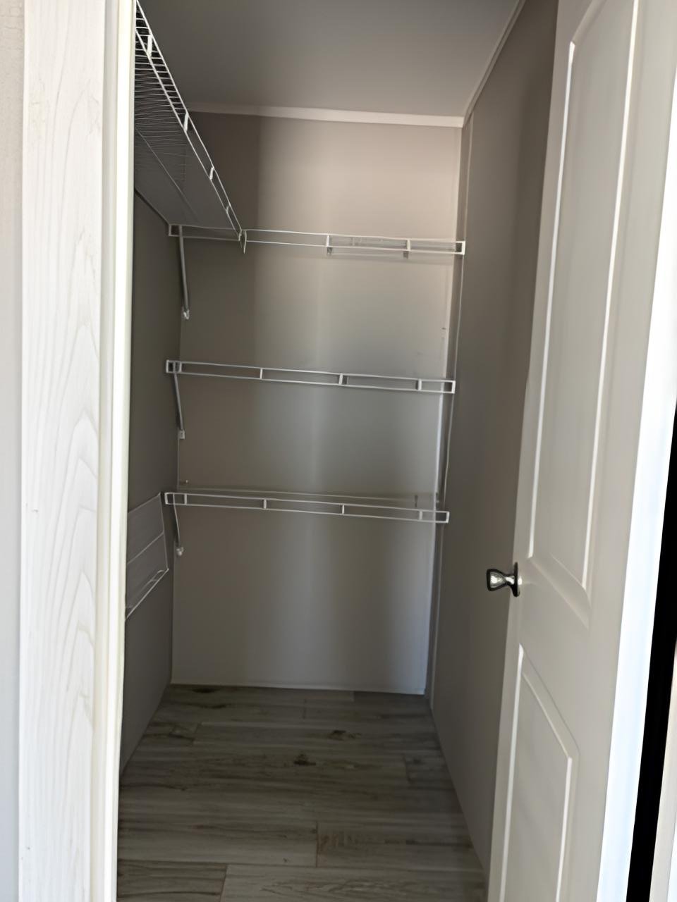 Walk-in closet with multiple storage shelves in Midland TX doublewide