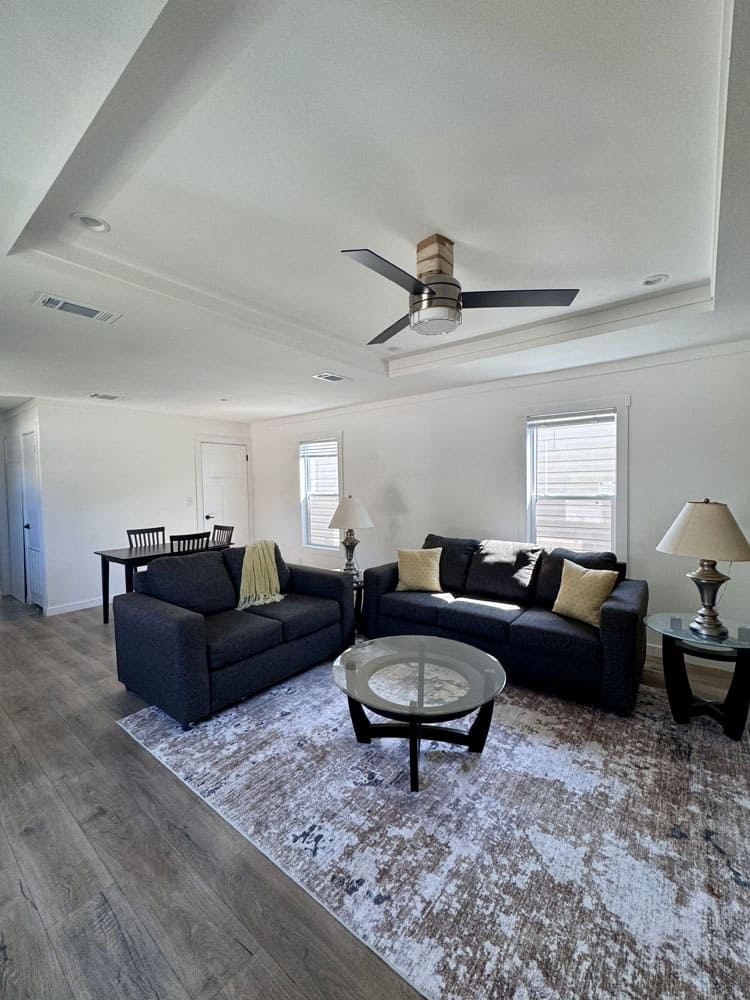 Open living area with tray ceiling in The Cami 3 bedroom mobile home at Premier Homes of Conroe