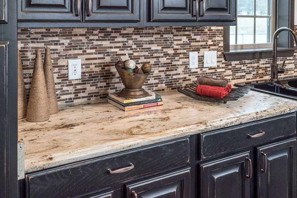 Stone-look counters and mosaic backsplash in The Nandina kitchen