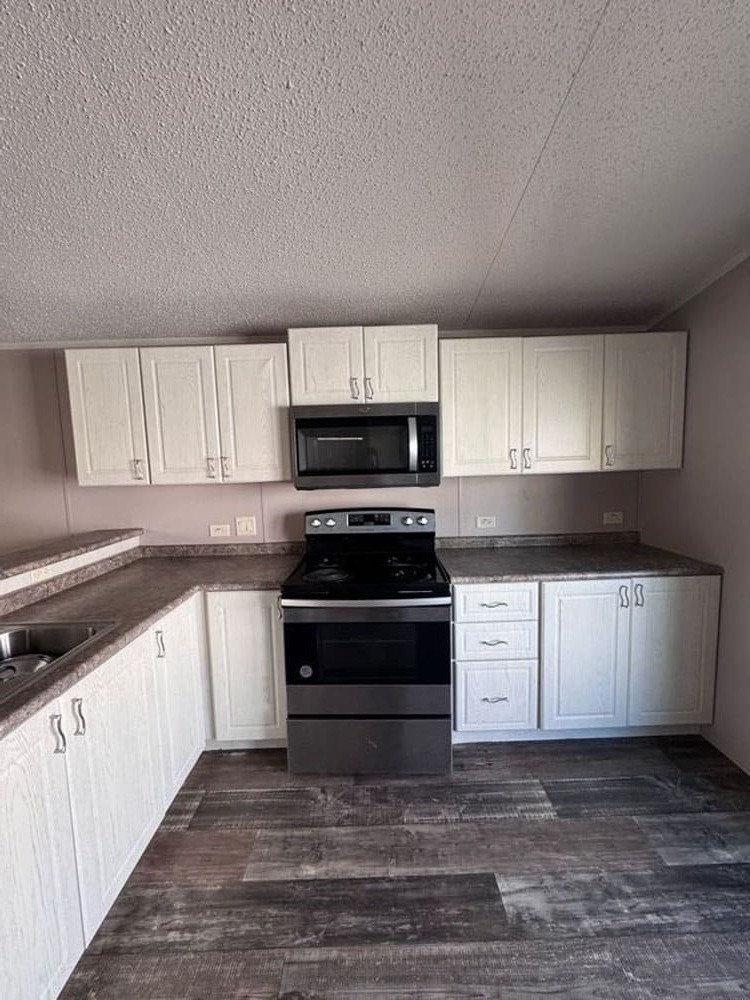 Modern Legacy Housing kitchen with abundant cabinets in The Leyla mobile home