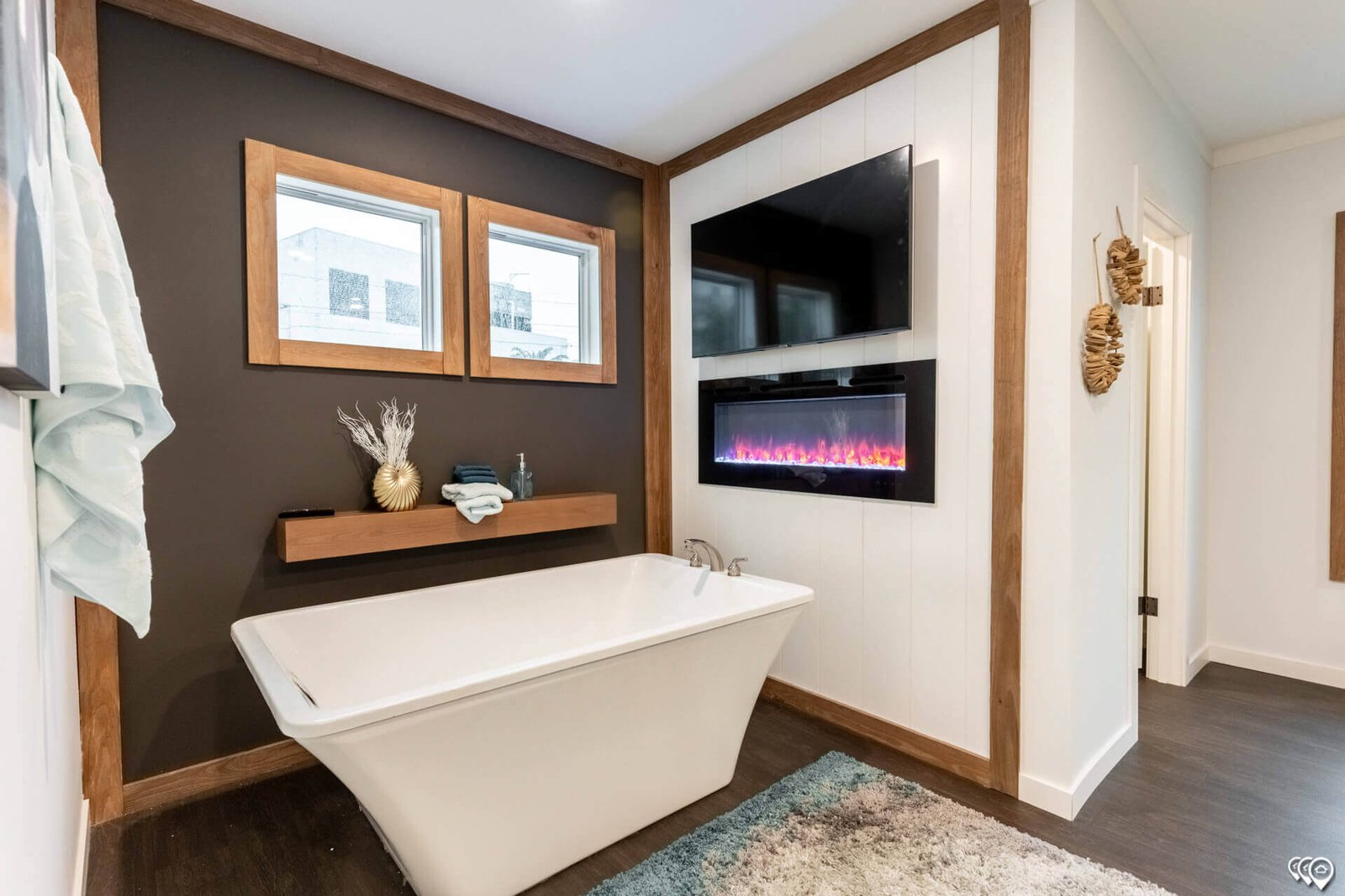 Primary bathroom soaking tub with fireplace feature in The Trinity CS-3242