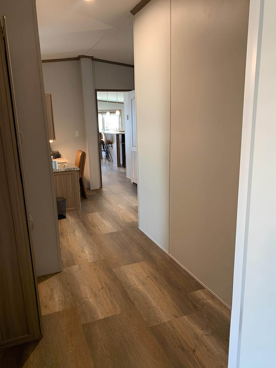 Wide interior hallway in the three-bedroom Lakehouse home in Bonham, TX
