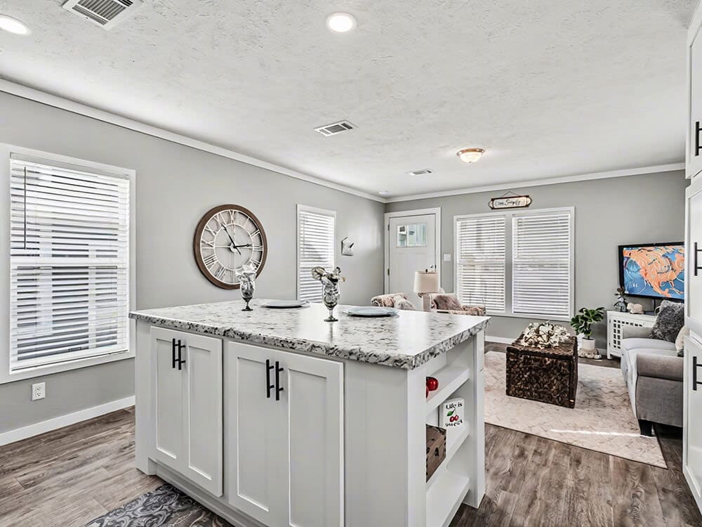 Open kitchen and living room in the compact two-bedroom Bobby Jo home