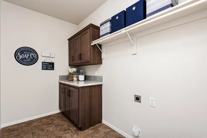 Utility laundry room by Champion Homes at Factory Mobile Homes Colorado