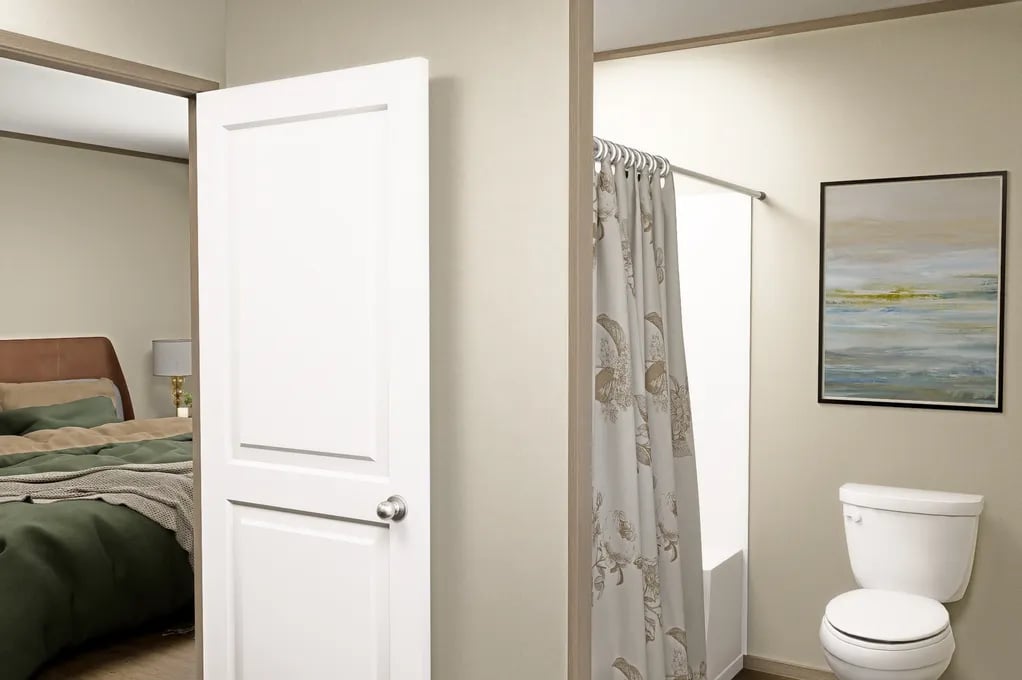 Private bedroom entry to the primary bath in this 1,140 sq. ft. single-wide home