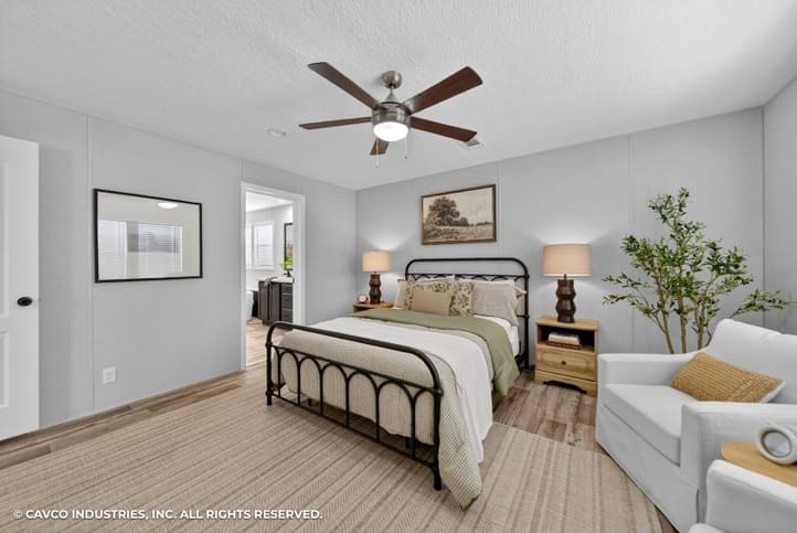 Staged primary bedroom in The Vantage double-wide manufactured home
