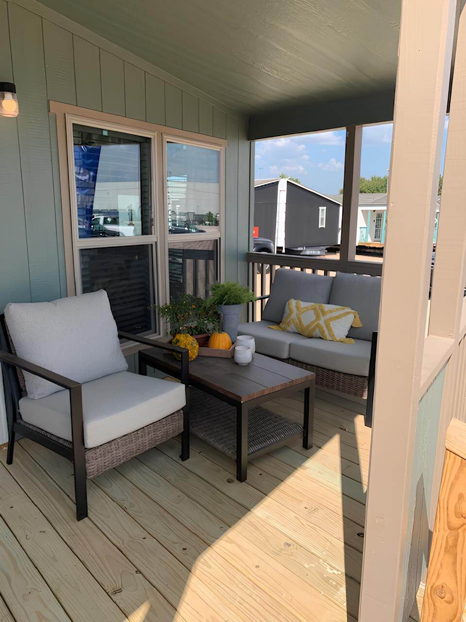 Covered porch seating on The Lakehouse 32x64 by Legacy Housing