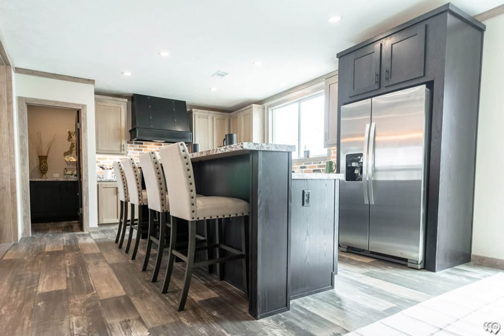 Large kitchen island and stainless refrigerator in The Shoal Creek