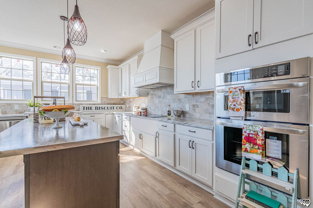 White farmhouse kitchen with stainless appliances in The Woodland