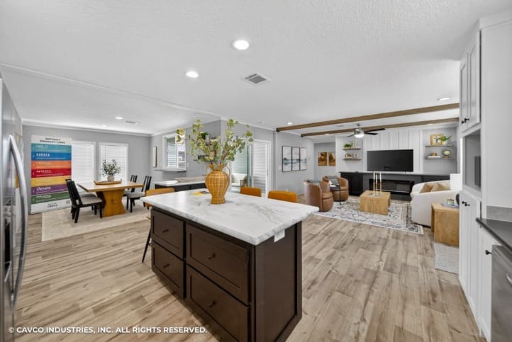 Open-concept kitchen, dining and living area in The Vantage by Cavco