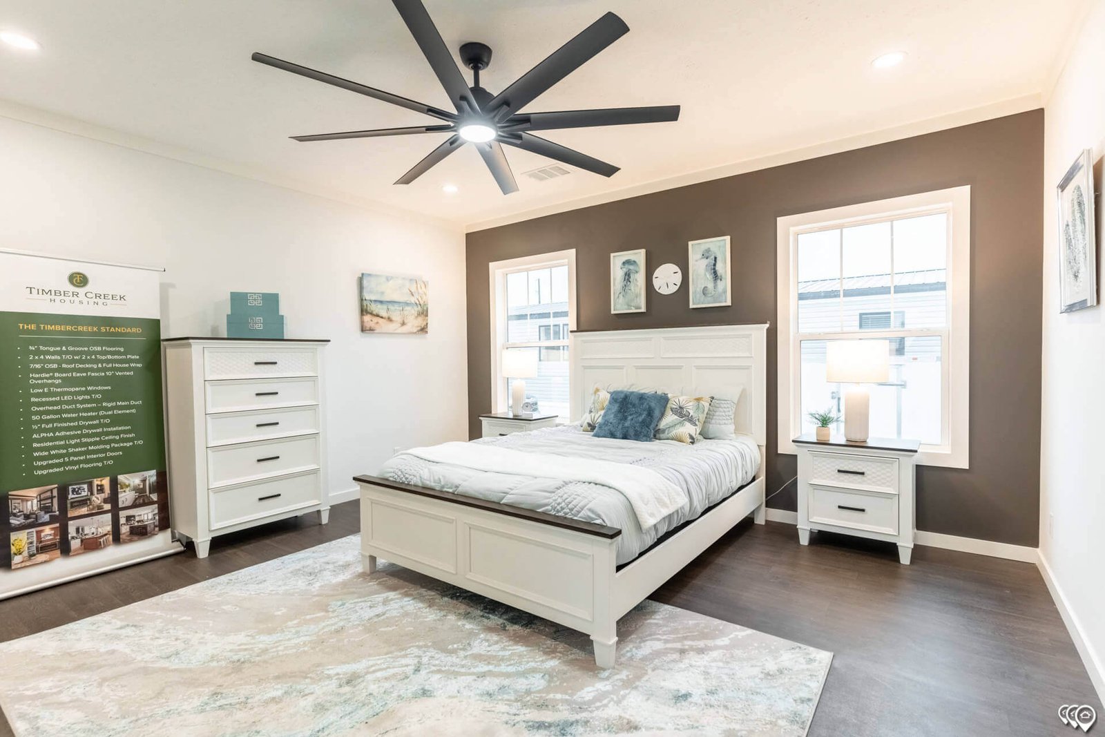 Primary bedroom with accent wall and large windows in The Trinity CS-3242