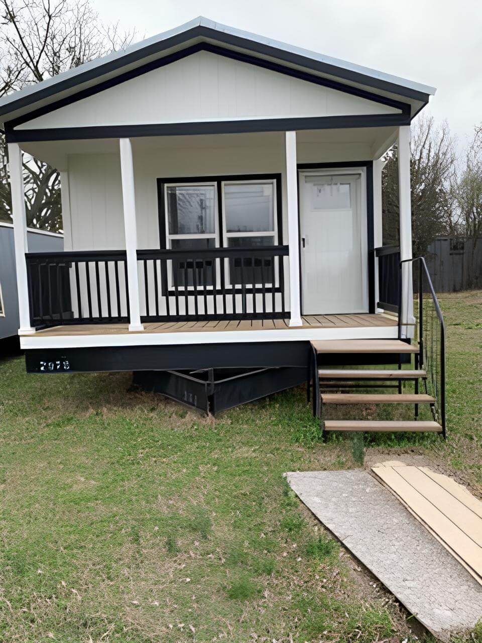 Black-and-white Bobby Jo exterior with porch and entry steps