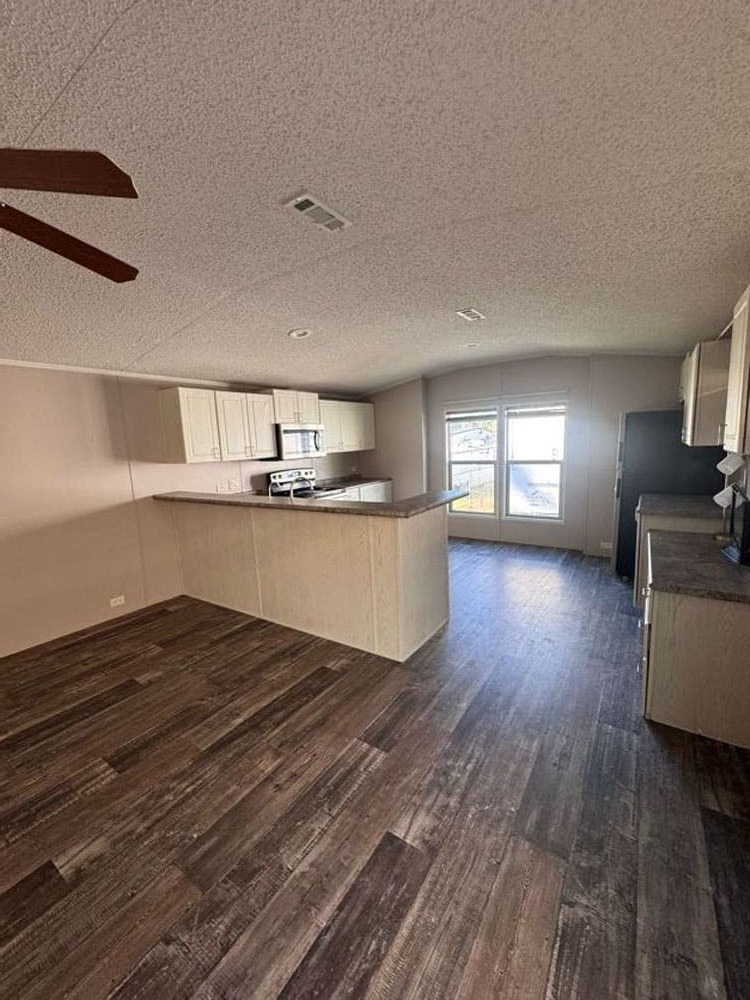 Open-concept kitchen and living area of The Leyla by Legacy Housing