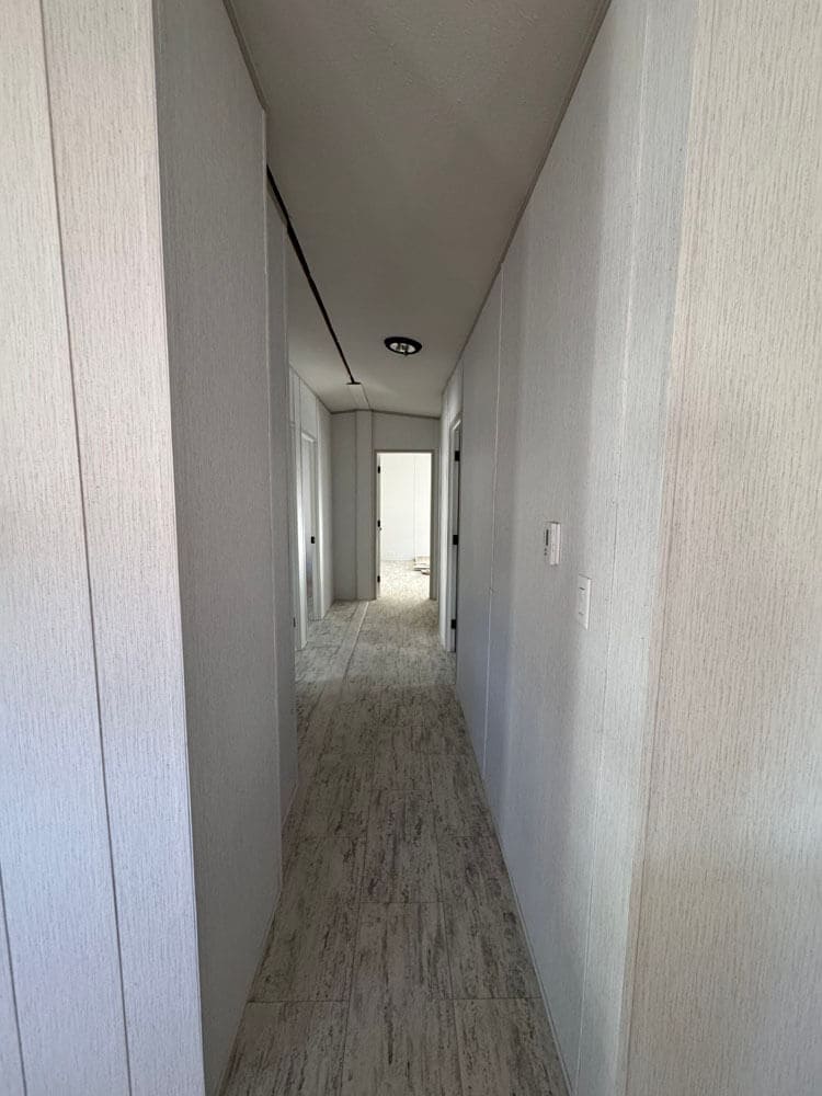 Interior hallway connecting the bedrooms in The Lucia doublewide