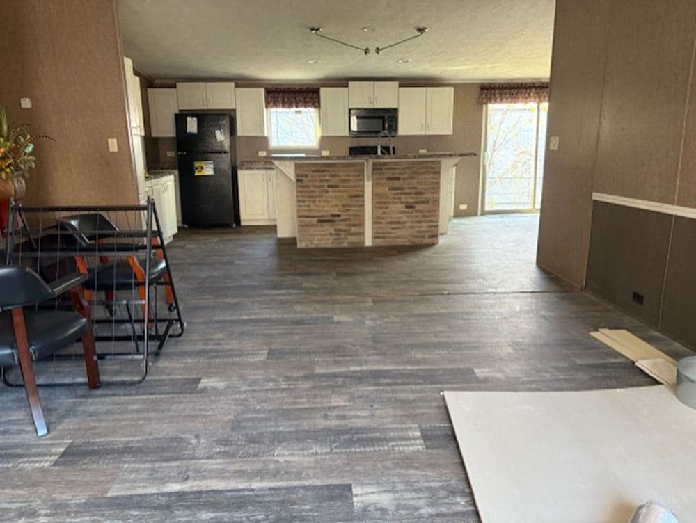 Open living area and kitchen inside The Leslie by Legacy Housing