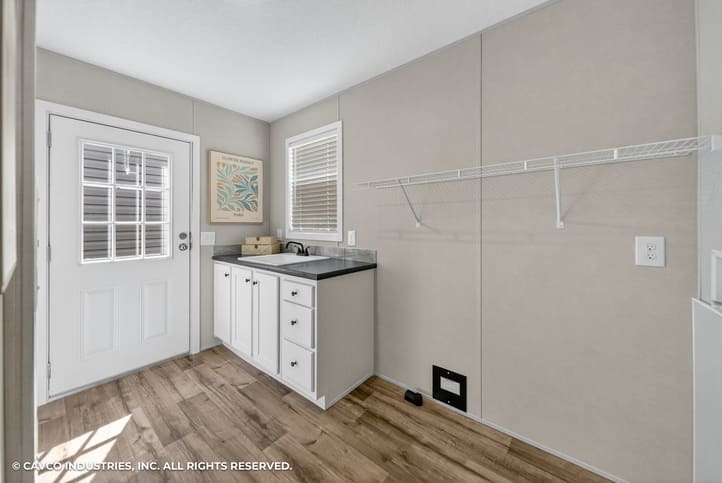 Utility and laundry room with sink and storage in The Vantage double-wide