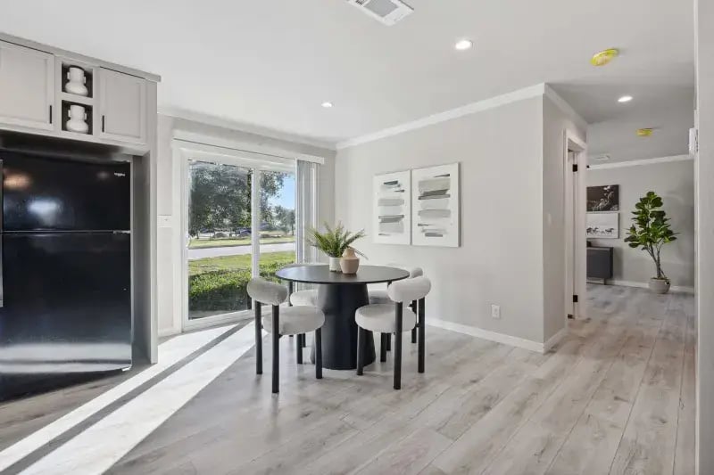 Dining area with round table and sliding glass door in The Carol 4-bedroom home
