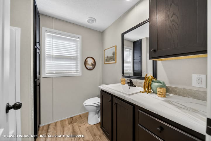 Guest bathroom with dark vanity in The Vantage by Cavco