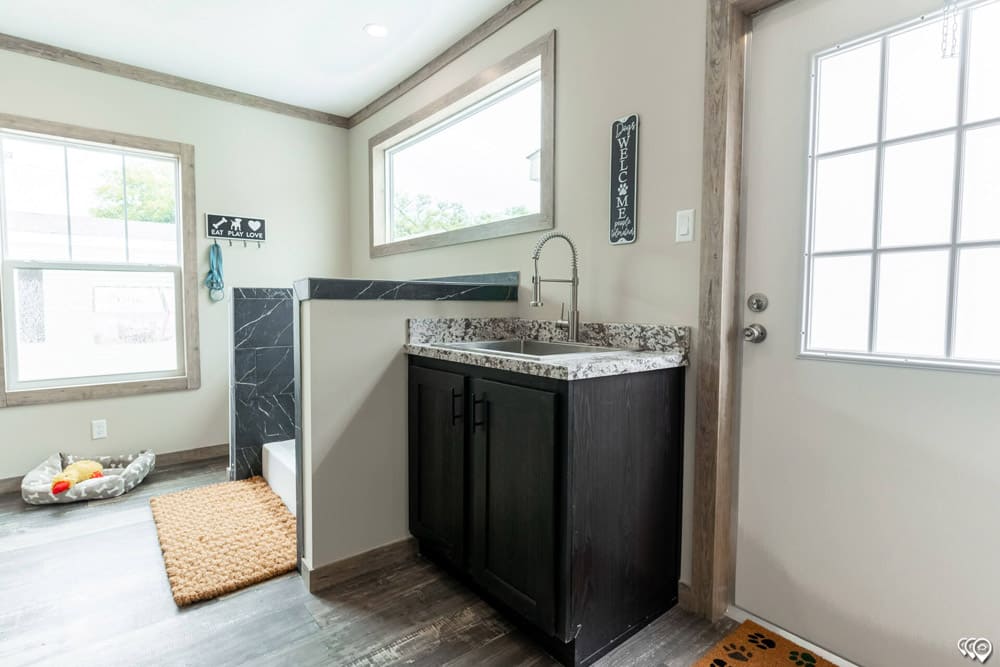 Pet wash mudroom with utility sink in this Bastrop County home for sale