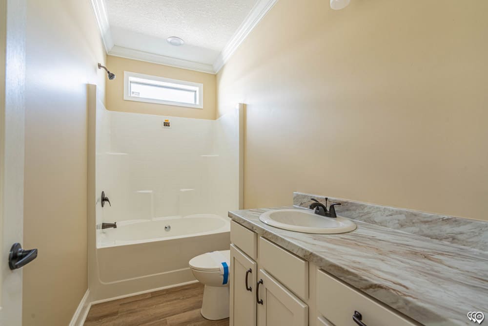 Guest bathroom with tub shower in The Woodland home for sale near Austin TX