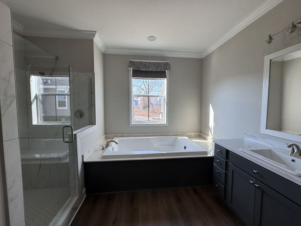 Soaking tub and glass shower in The Lilly II primary bathroom