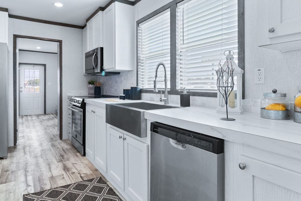 Farmhouse sink and dishwasher in the Jessup Royal manufactured home kitchen