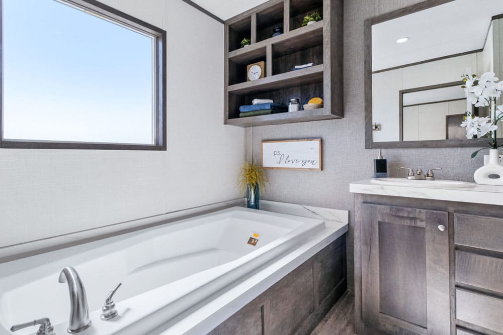 Primary bathroom soaking tub and vanity in The Wilson single-wide manufactured home