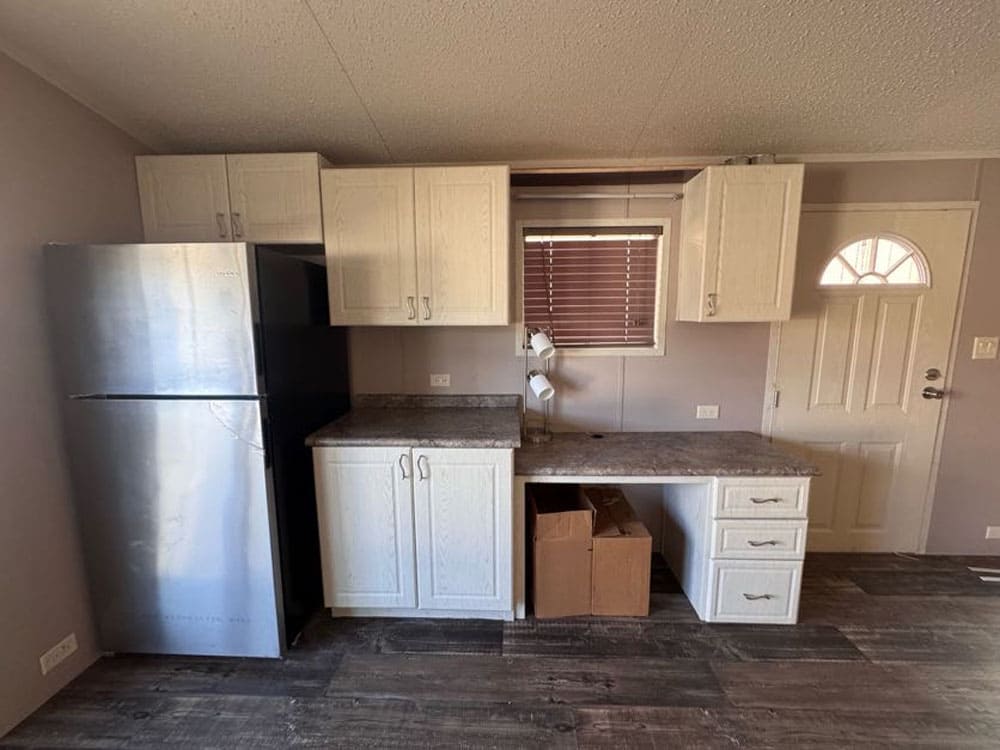Kitchen refrigerator and built-in workspace in The Leyla singlewide home