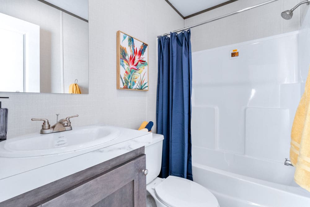 Guest bathroom with tub-shower in The Wilson 3-bed, 2 bath single-wide home