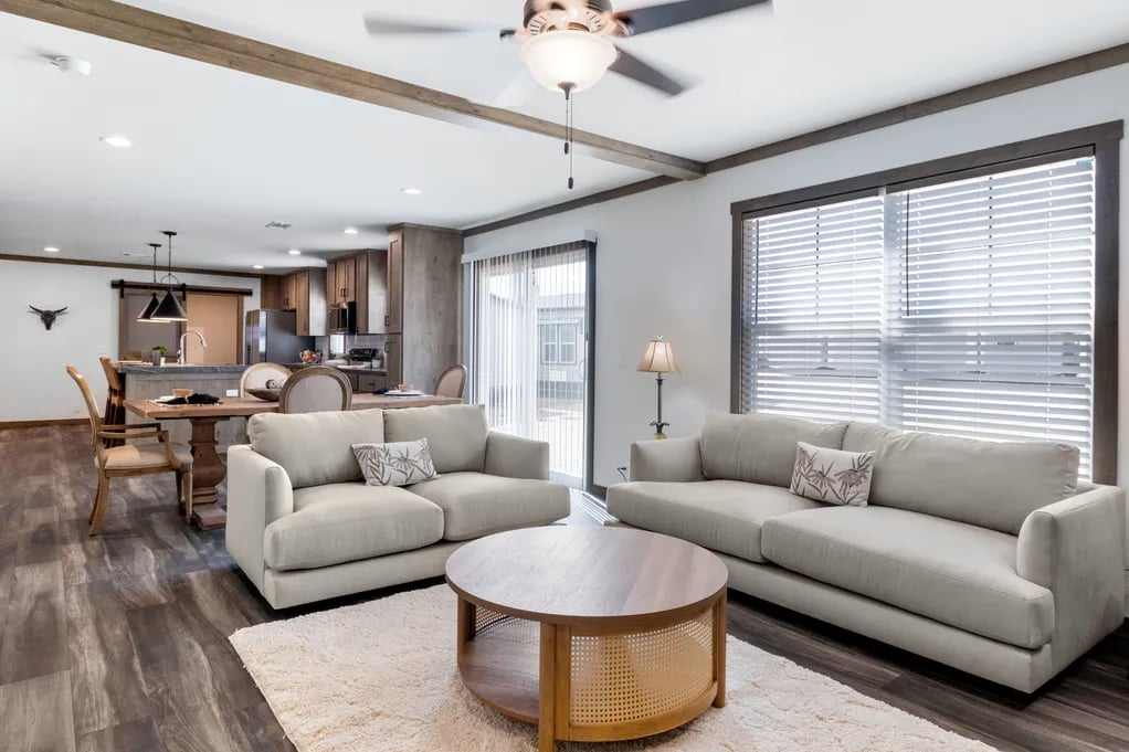 Open family room flowing into the dining area and kitchen in the Isabella Elite double-wide
