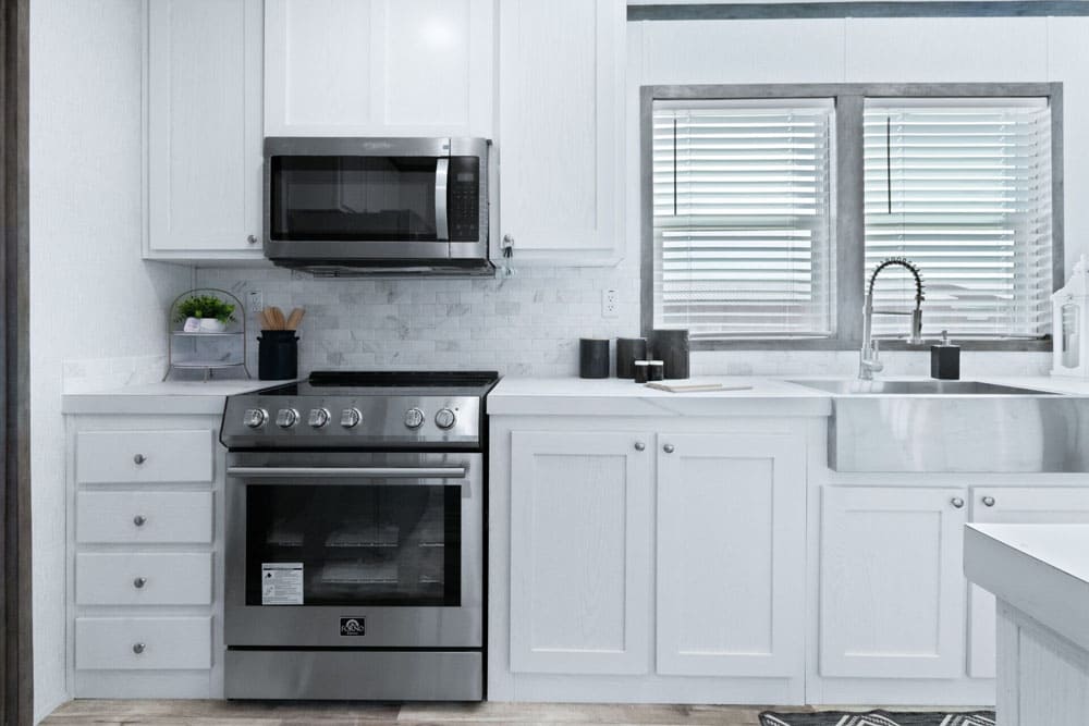 White kitchen with farmhouse sink in the Jessup Royal double-wide