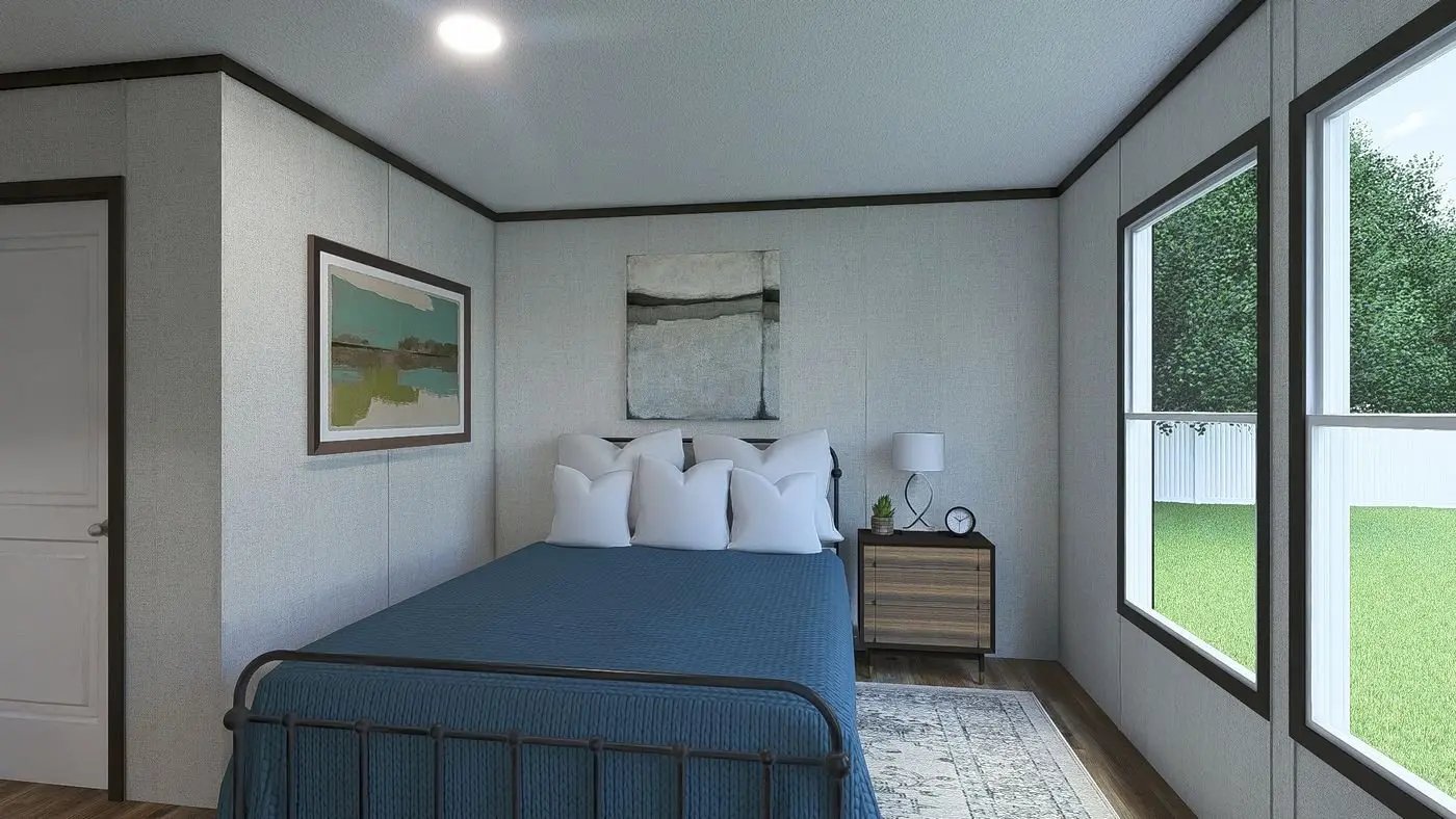 Bright guest bedroom with tall windows in a 4-bed 2 bath manufactured home