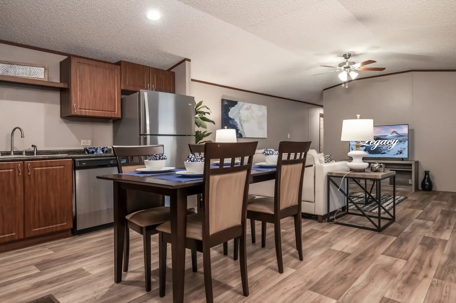 Dining area in The Lisa by Legacy Housing with seating for four and open views of the kitchen and living room