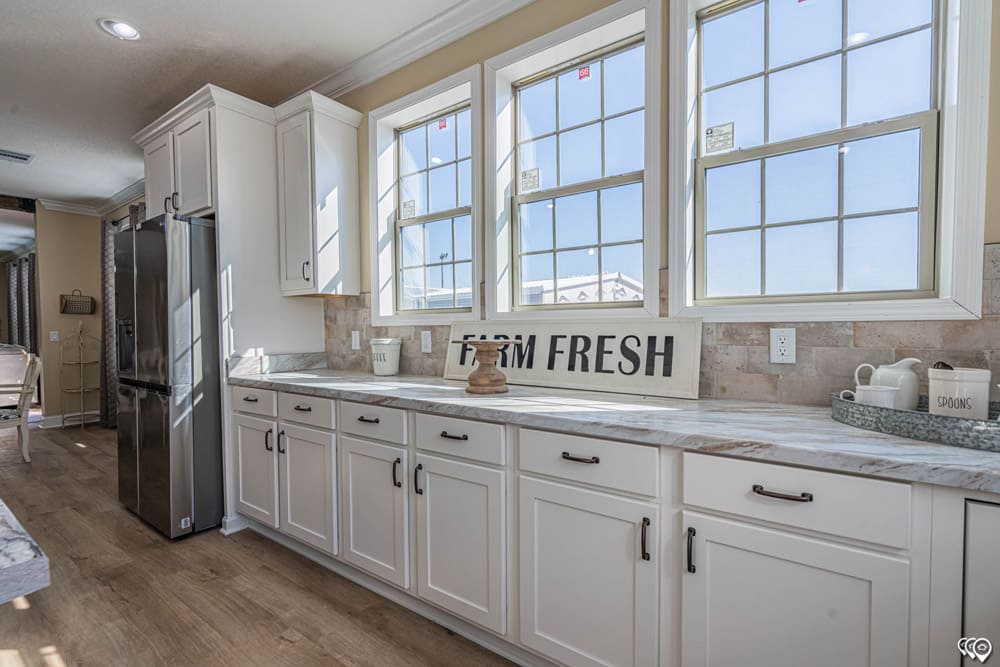 Abundant kitchen cabinets and windows in The Woodland by Franklin Homes