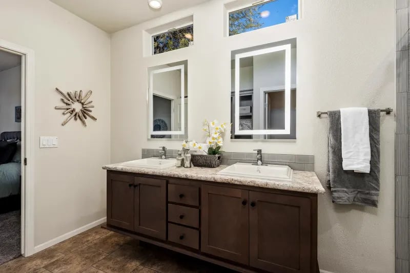 Primary bathroom vanity in The Odyssey XL 3256 by Champion Homes