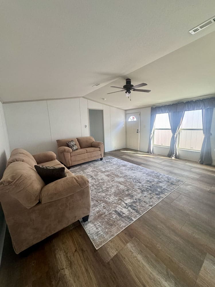 Bright front living room of a large manufactured home for sale at Premier Homes of Conroe