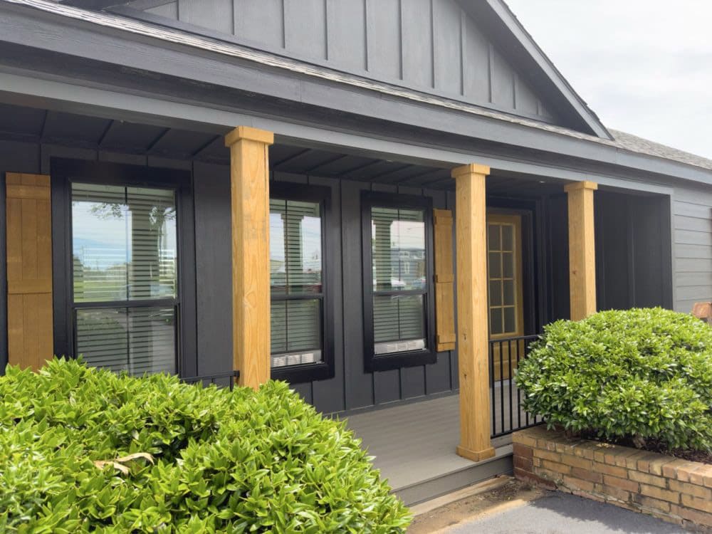 Covered front porch with wood columns on The Riverwalk