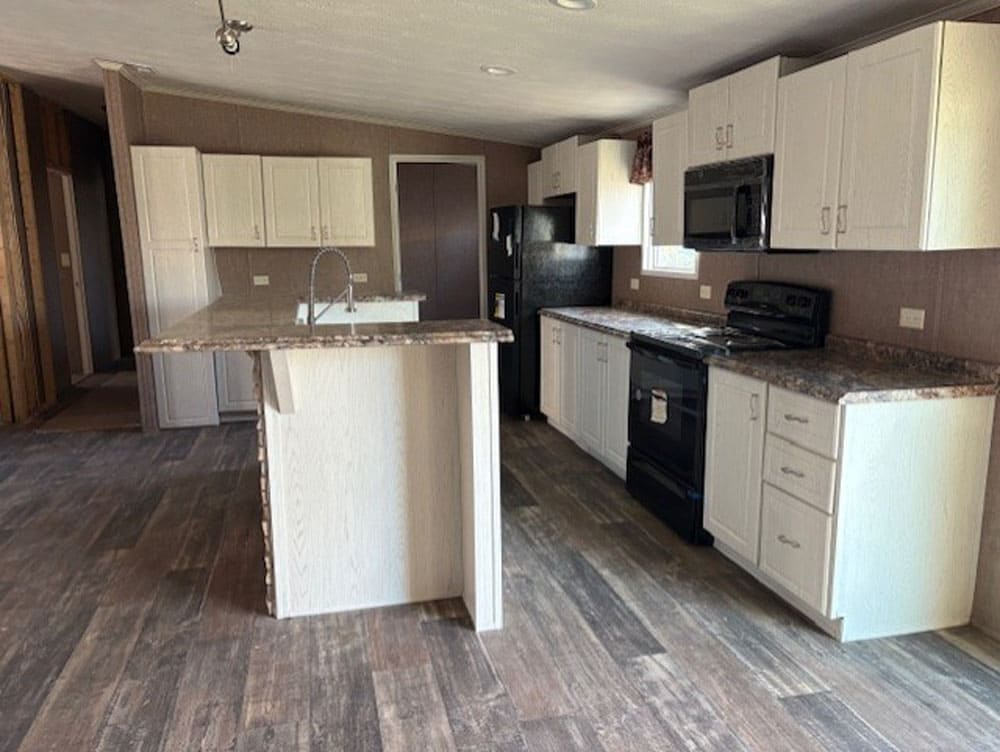 Large island kitchen in the 2,120-square-foot Leslie 5-bedroom home at Premier Homes of Conroe