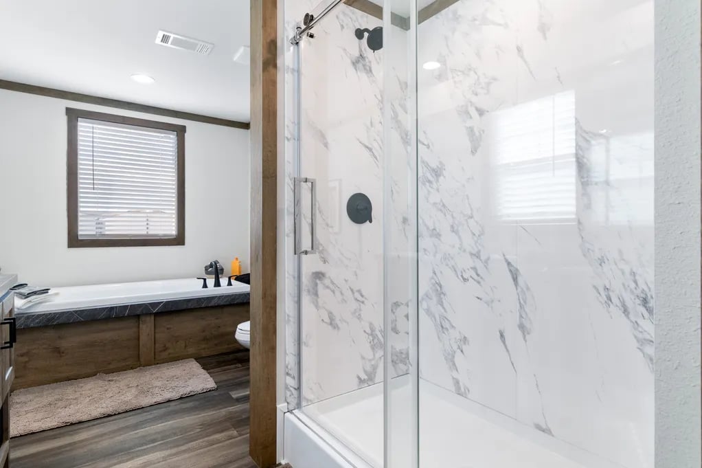 Marble-look walk-in shower and soaking tub in the Isabella Elite manufactured home