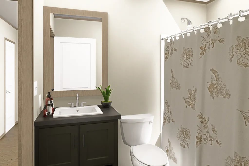 Guest bathroom with vanity, toilet and shower in the 3-bed, 2-bath Clayton Epic Mariner