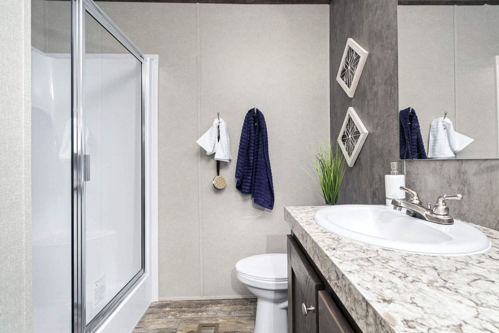 Guest bathroom with shower in The Grant manufactured home