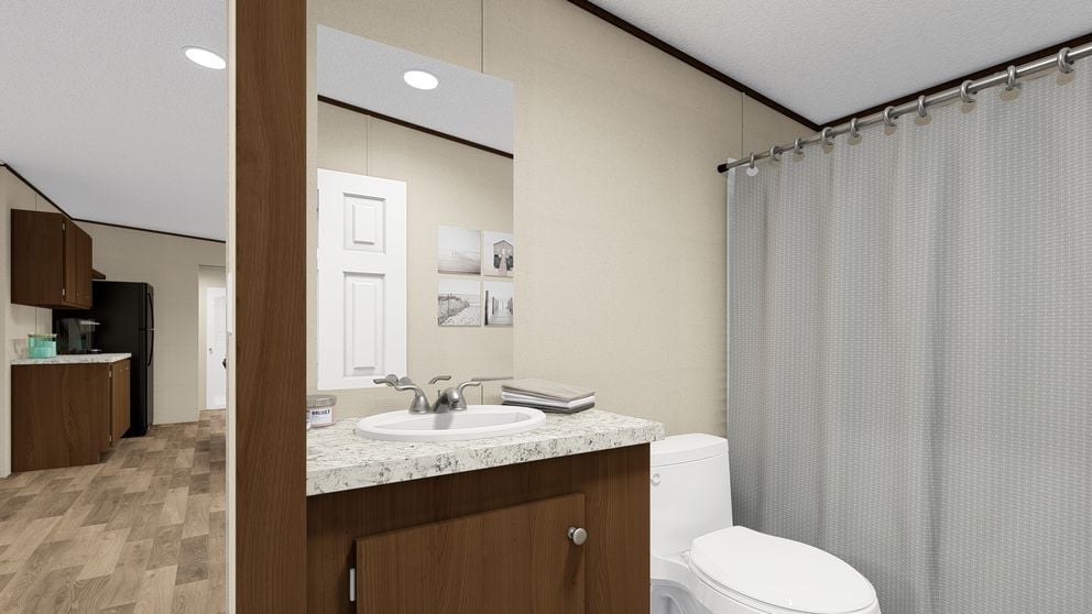 Guest bathroom with tub and shower combo in The Thrill by TRU Homes