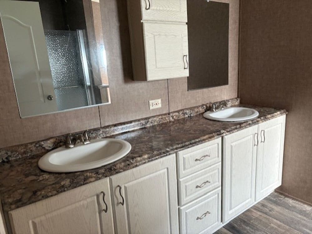 Primary bathroom double vanity in Legacy Housing model C-3272-53B at Premier Homes of Conroe