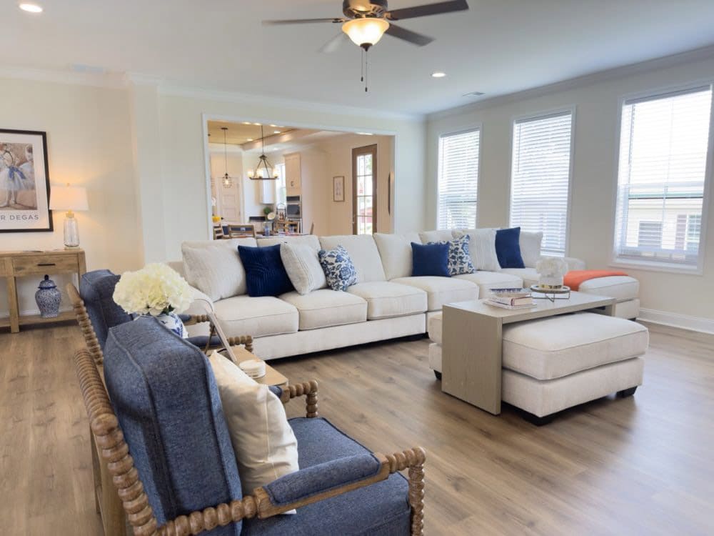 Bright living room with sectional seating in The Riverwalk mobile home