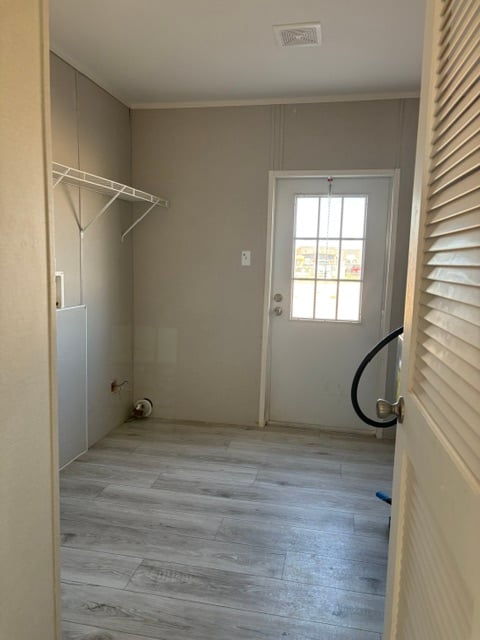 Utility and laundry room with exterior door in used repo manufactured home
