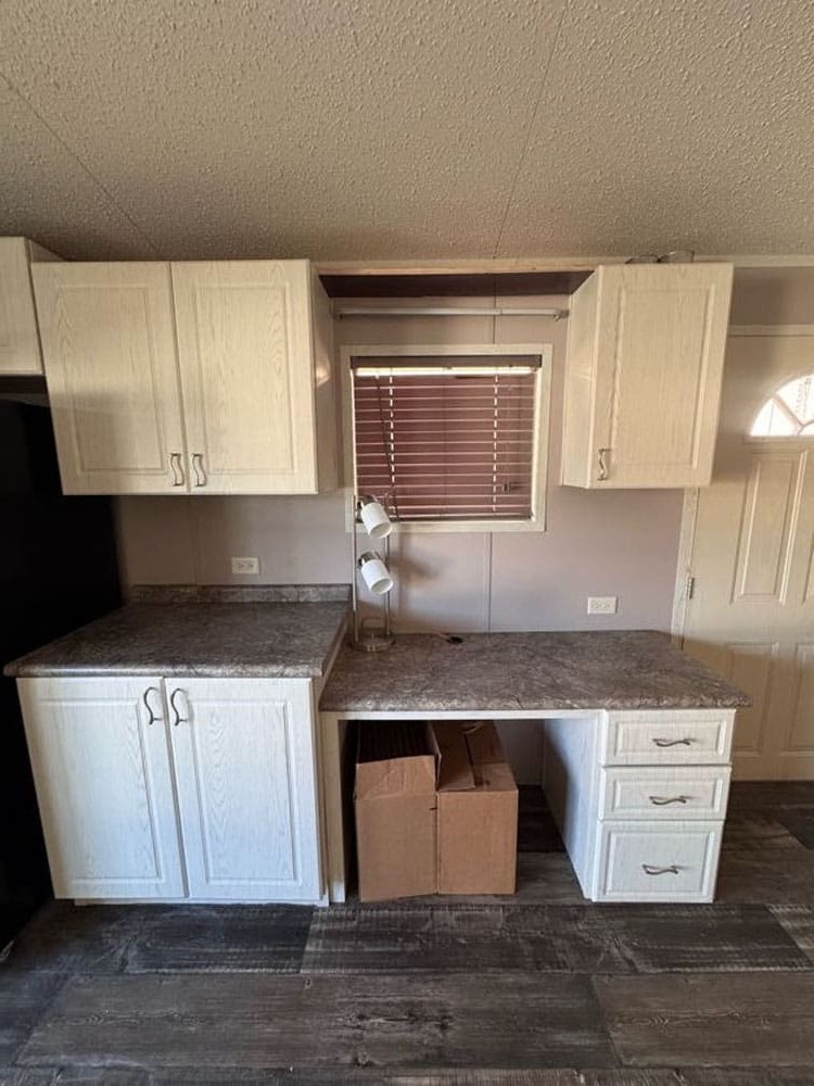 Built-in kitchen desk and storage in The Leyla C-1656-21FKA manufactured home