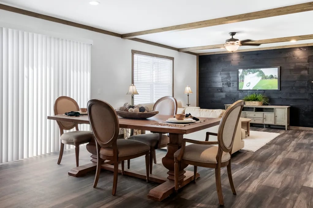 Dining area and second living room with dark accent wall in the Isabella Elite